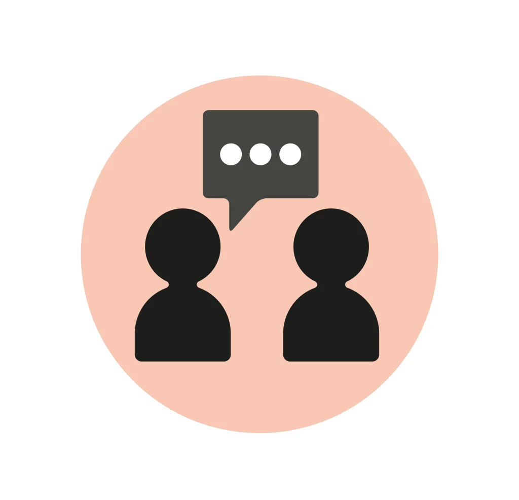 Icon of two people talking, above them is a speech bubble with three circles inside of it. 